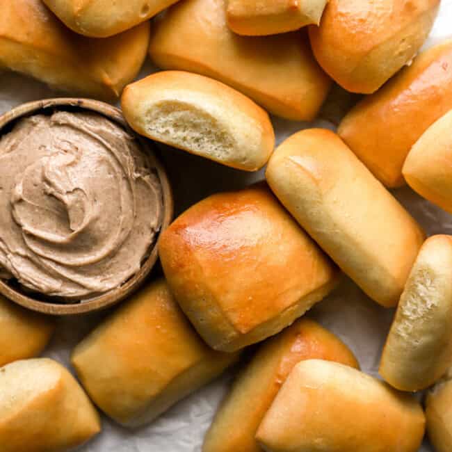 overhead view of texas roadhouse rolls with honey cinnamon butter.