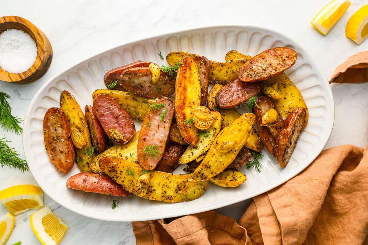 overhead view of fingerling potatoes on a white platter.