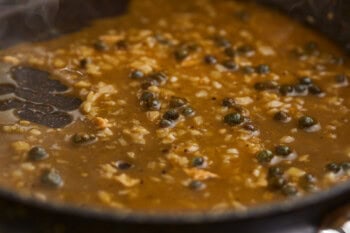 thickened lemon pepper sauce with capers in a pan.