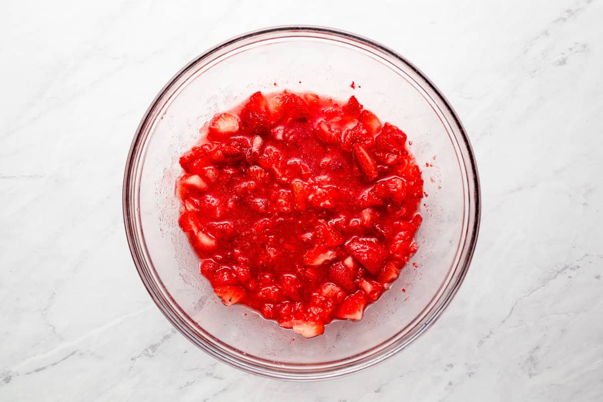 macerated strawberries in a glass bowl.