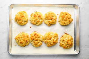 8 baked biscuits on a baking sheet.