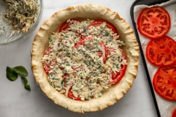 cheese filling over sliced tomatoes in a prebaked pie crust.