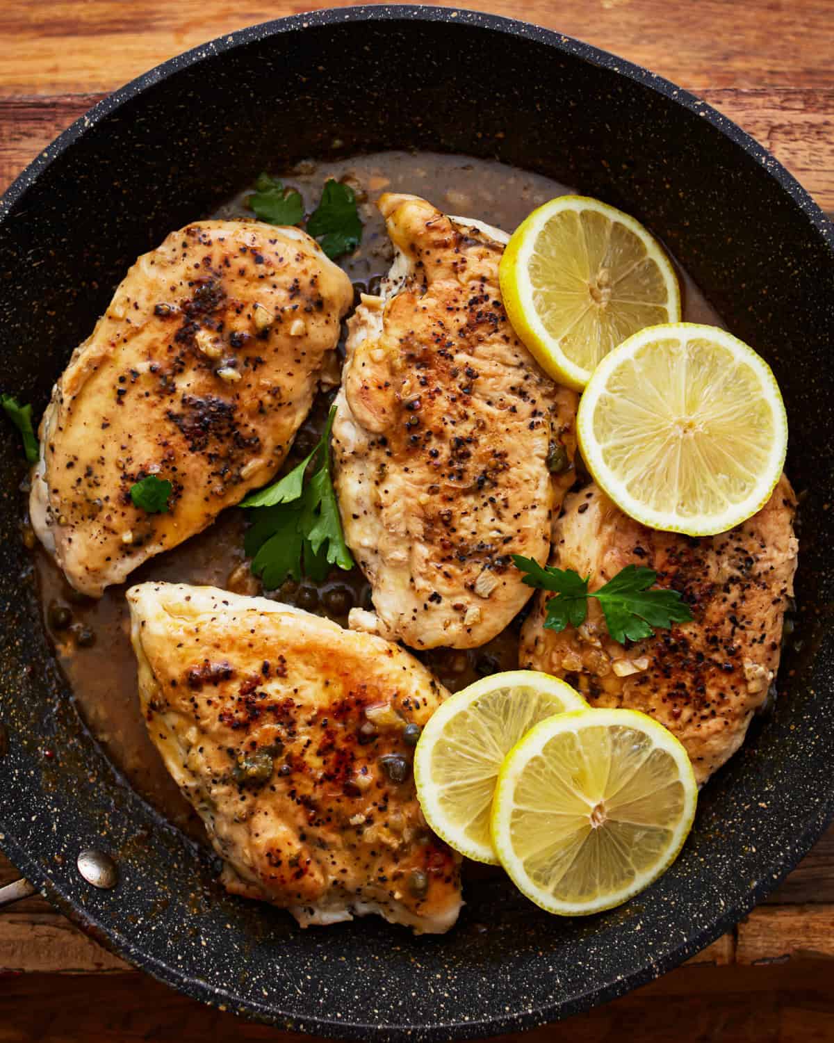 lemon pepper chicken in a pan.