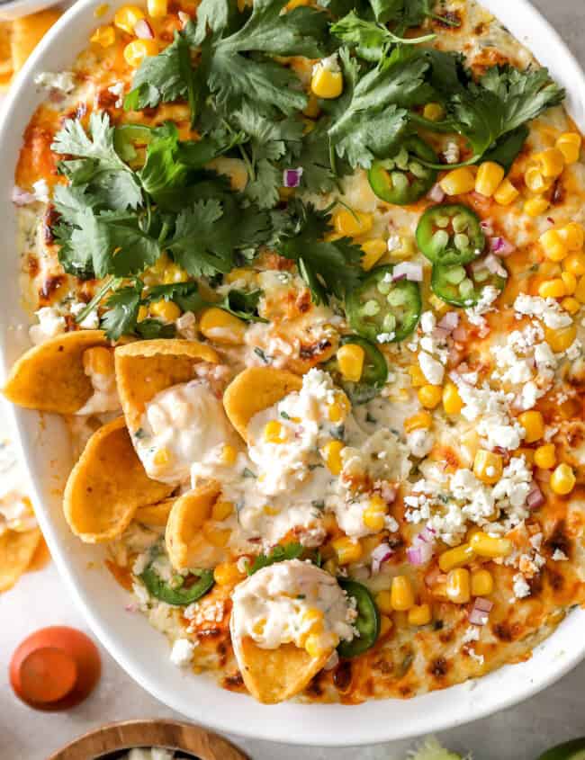 overhead view of mexican street corn dip in an oval baking dish.