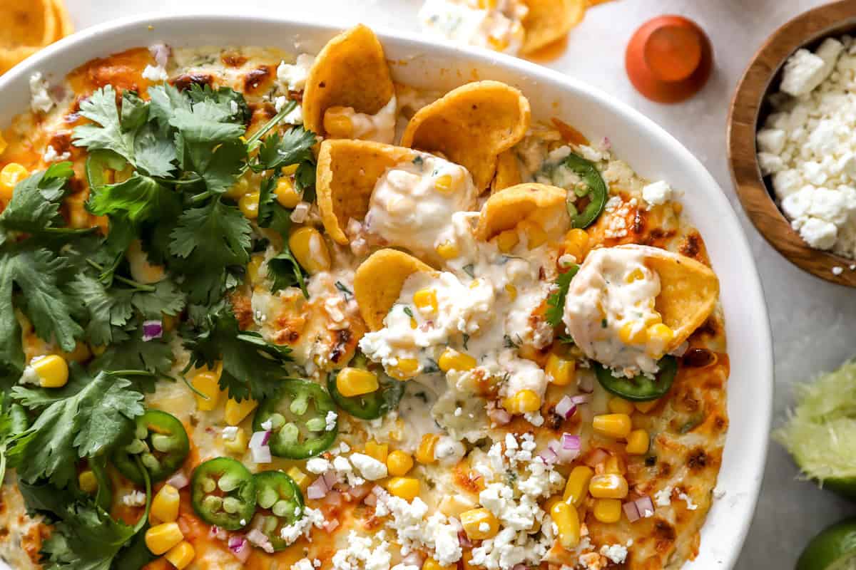 mexican street corn dip in an oval baking dish.