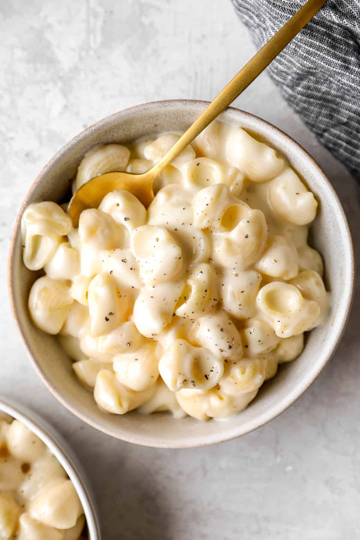 overhead view of a bowl of panera mac and cheese with a spoon.