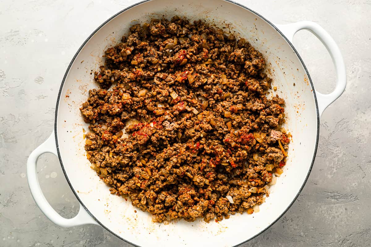 seasoned ground beef and tomato paste combined in a pot.