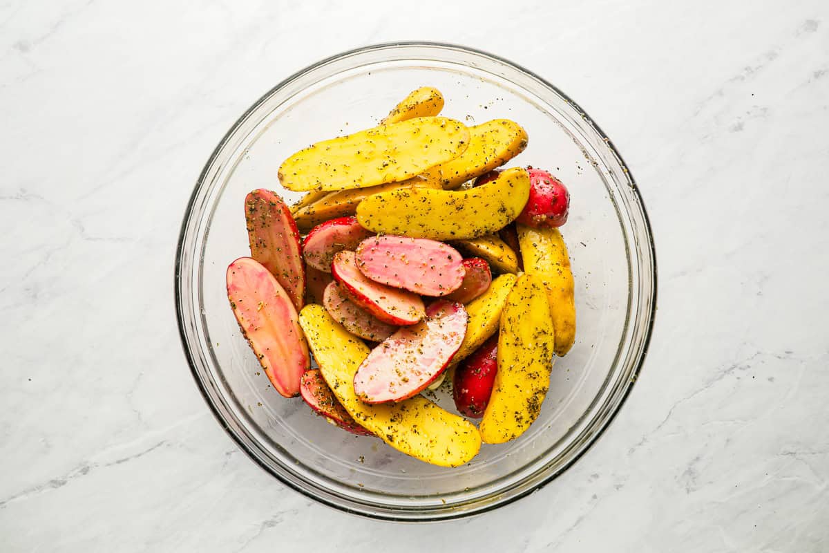 halved fingerling potatoes tossed in oil and spices.