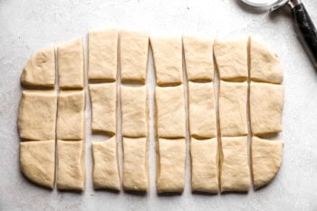 a rolled out rectangle of dough cut into 24 rolls.