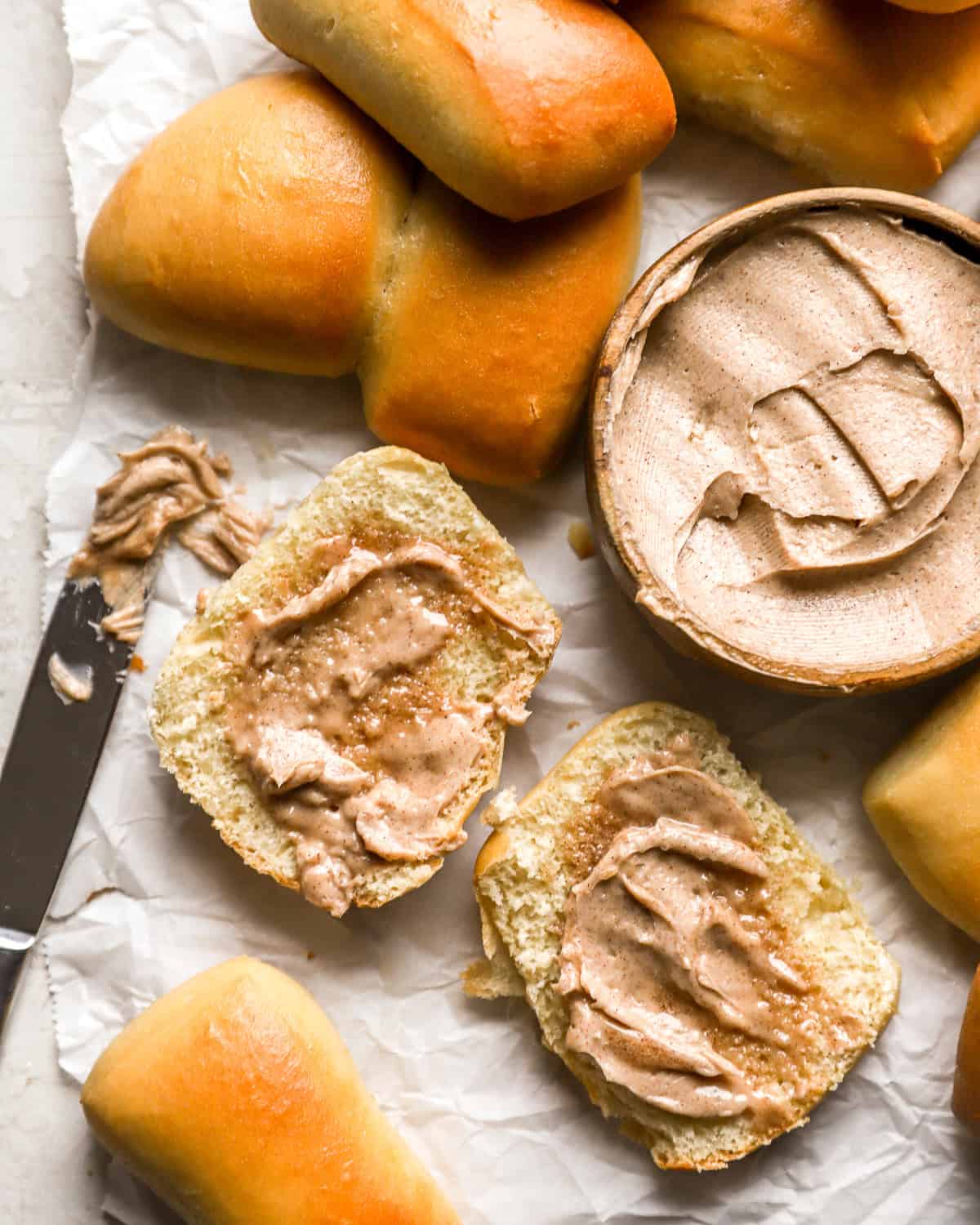 overhead view of a halved roll spread with texas roadhouse butter.