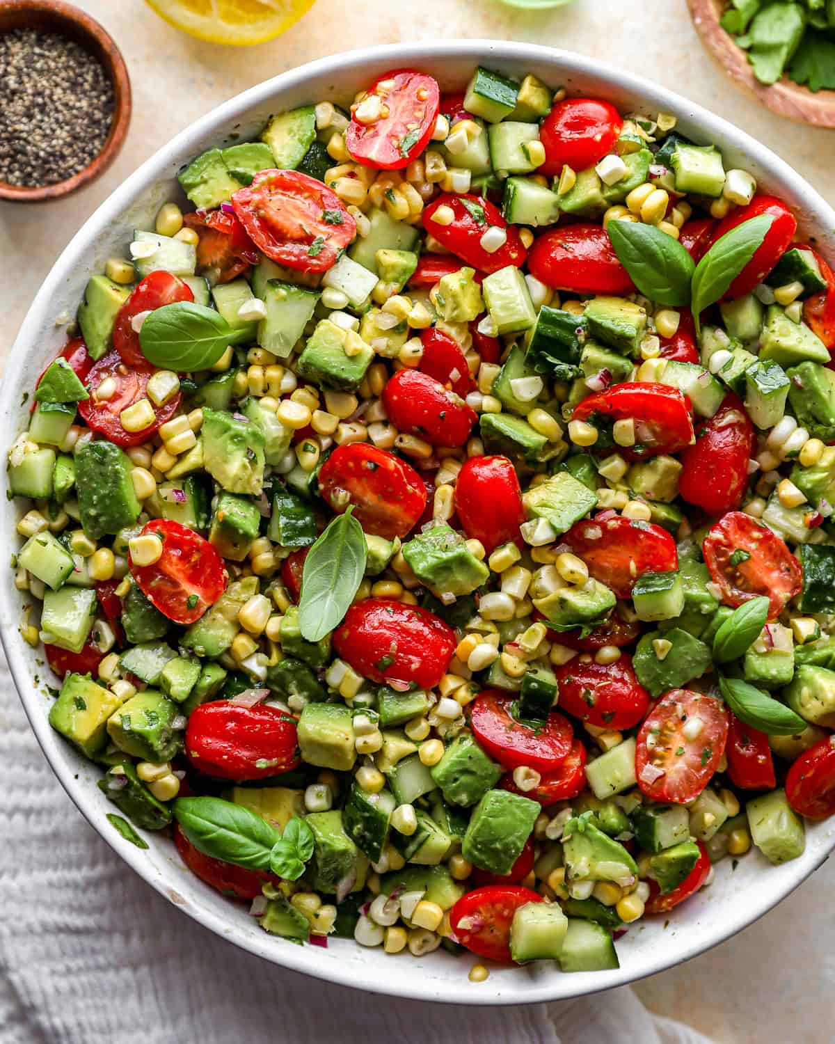 close up overhead view of avocado salad in a white bowl.