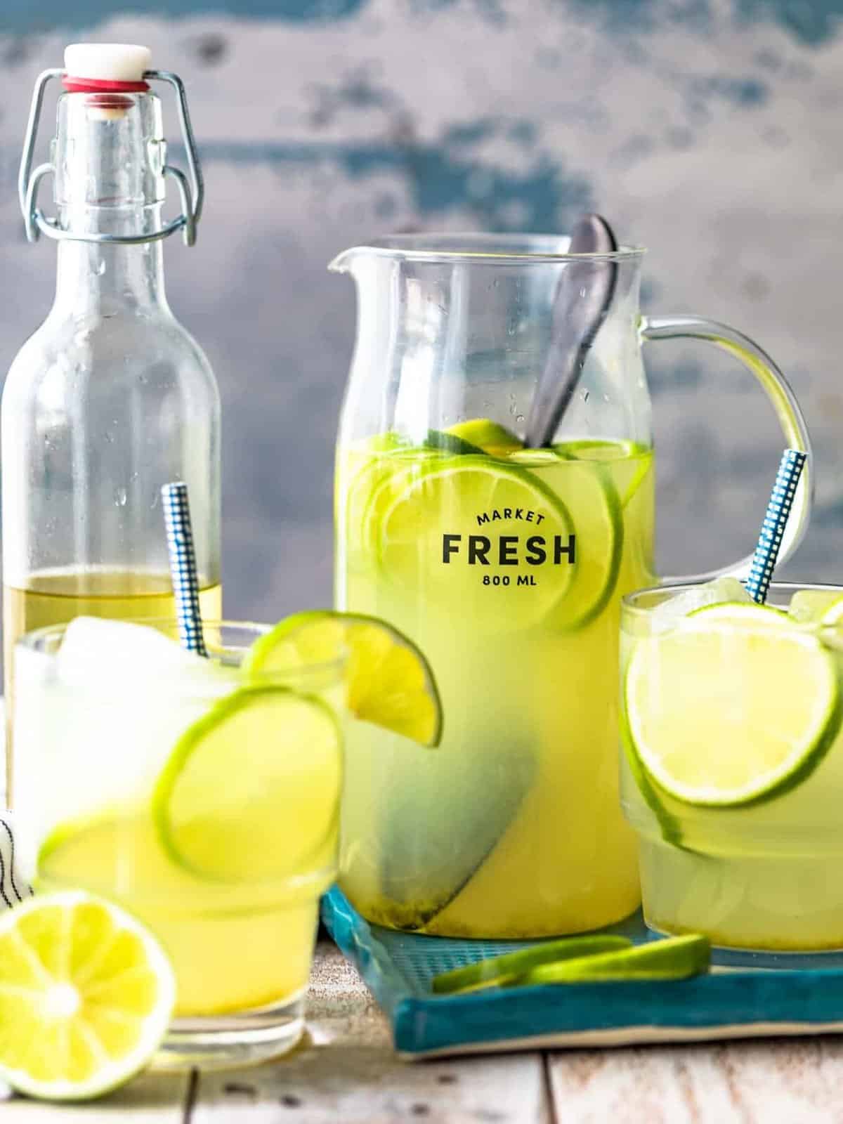 a pitcher and two glasses of limeade