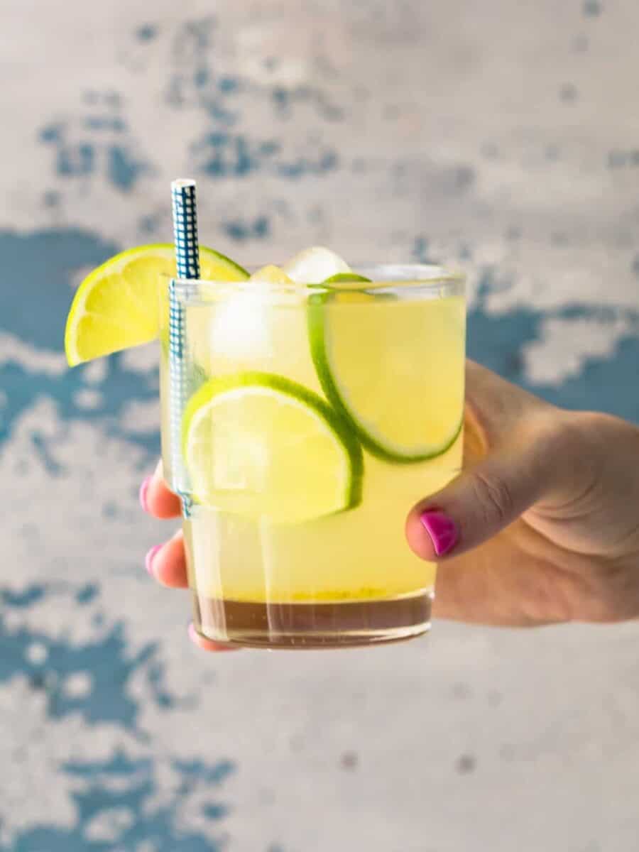 hand holding glass of homemade limeade