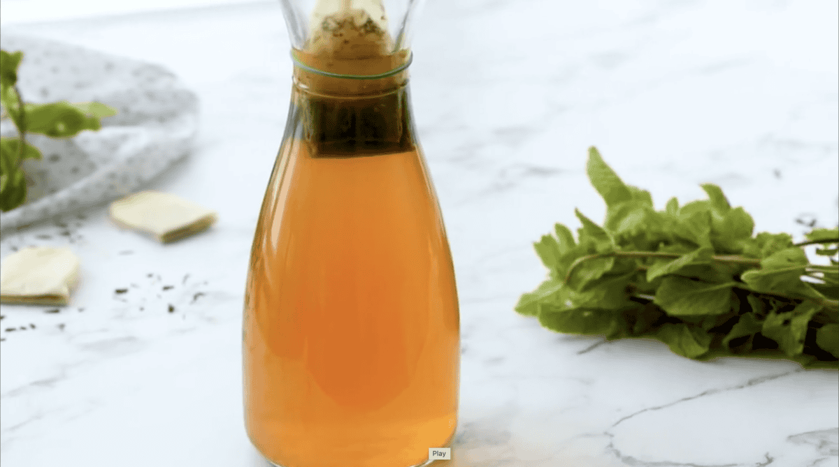 Tea bags brewing in a glass pitcher.