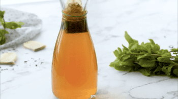 Tea bags brewing in a glass pitcher.