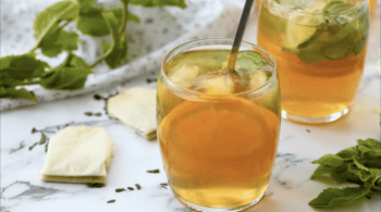 Stirring a simple syrup into a glass of iced tea.