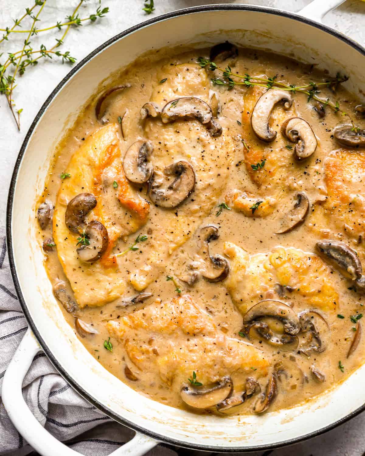 partial overhead view of mushroom chicken in a Dutch oven.