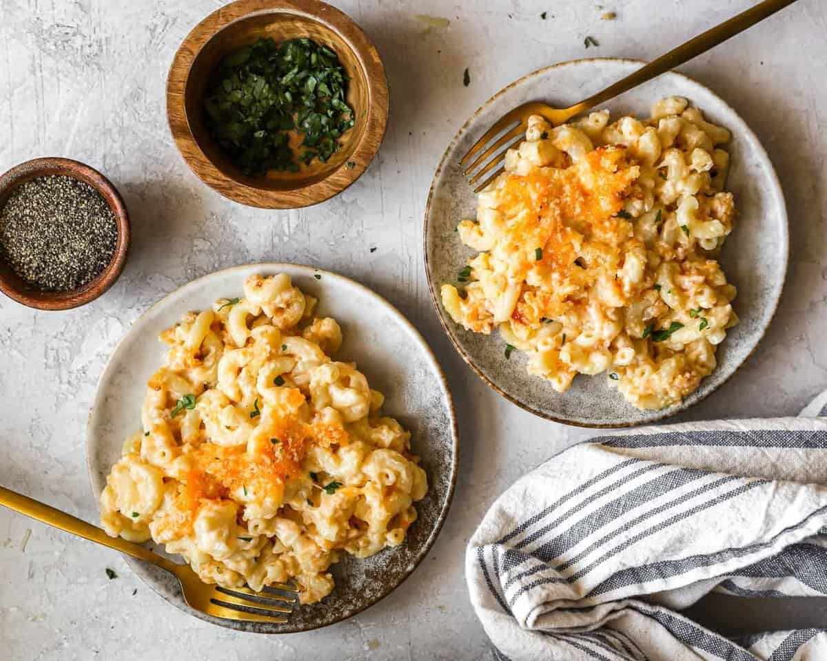 overhead view of two servings of baked mac and cheese on plates.