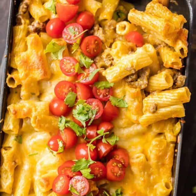 MEXICAN MAC AND CHEESE can't be beat! No need to fool with a tricky cheese sauce when you have this secret ingredient making things extra creamy and delicious. Spicy sausage and green chiles make this baked macaroni and cheese recipe soooo tasty!