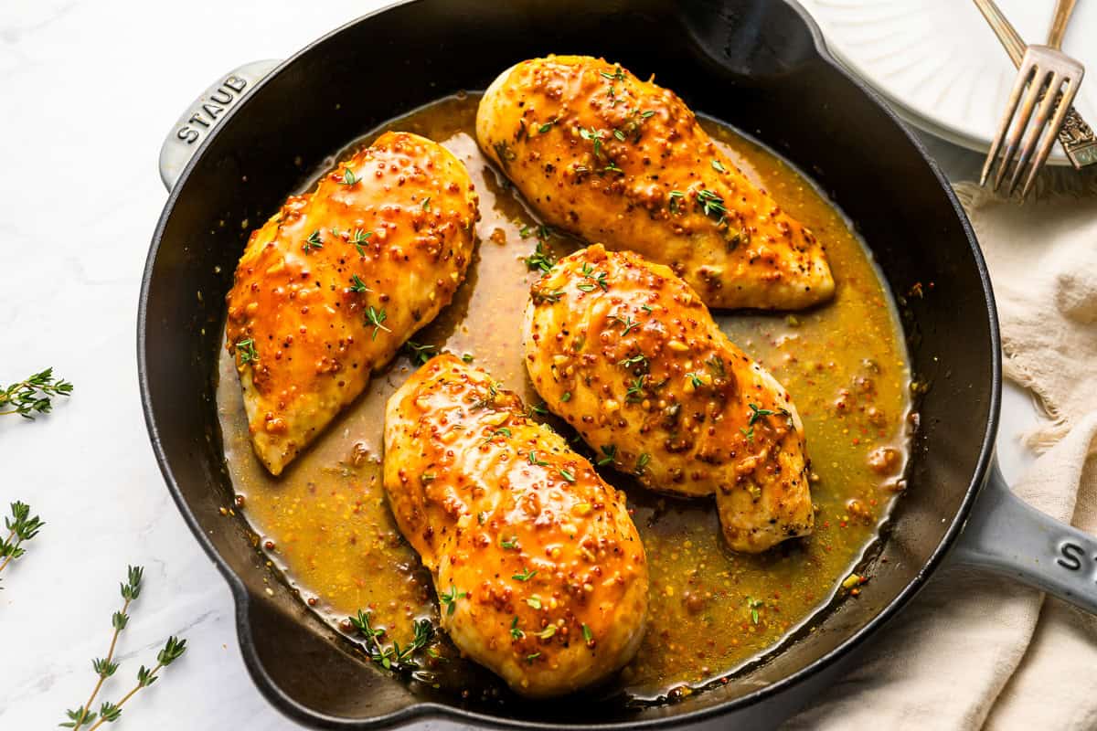 honey mustard chicken breasts in a cast iron skillet.