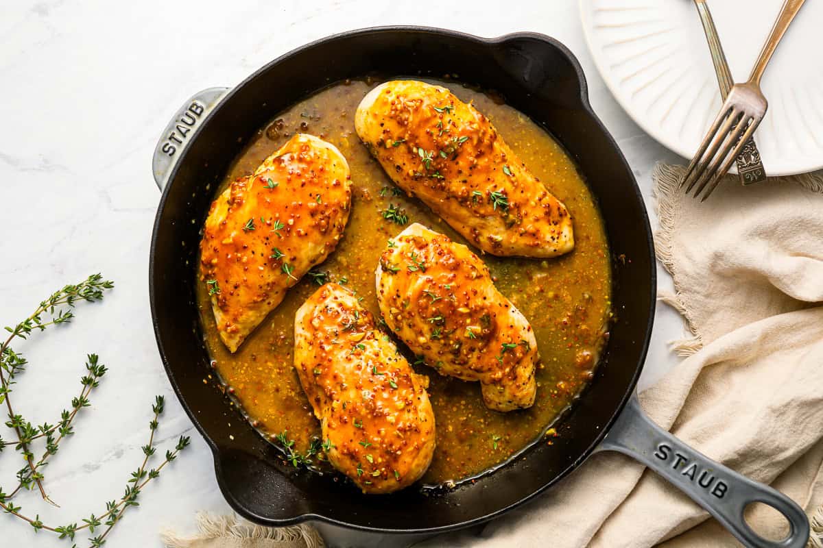 honey mustard chicken in a cast iron skillet.