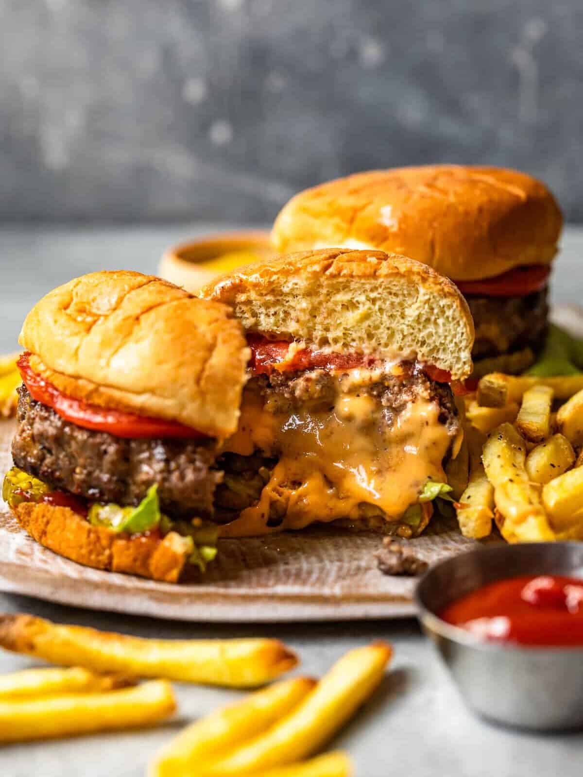 cheese stuffed burger cut in half on a plate showing the melted cheese filling