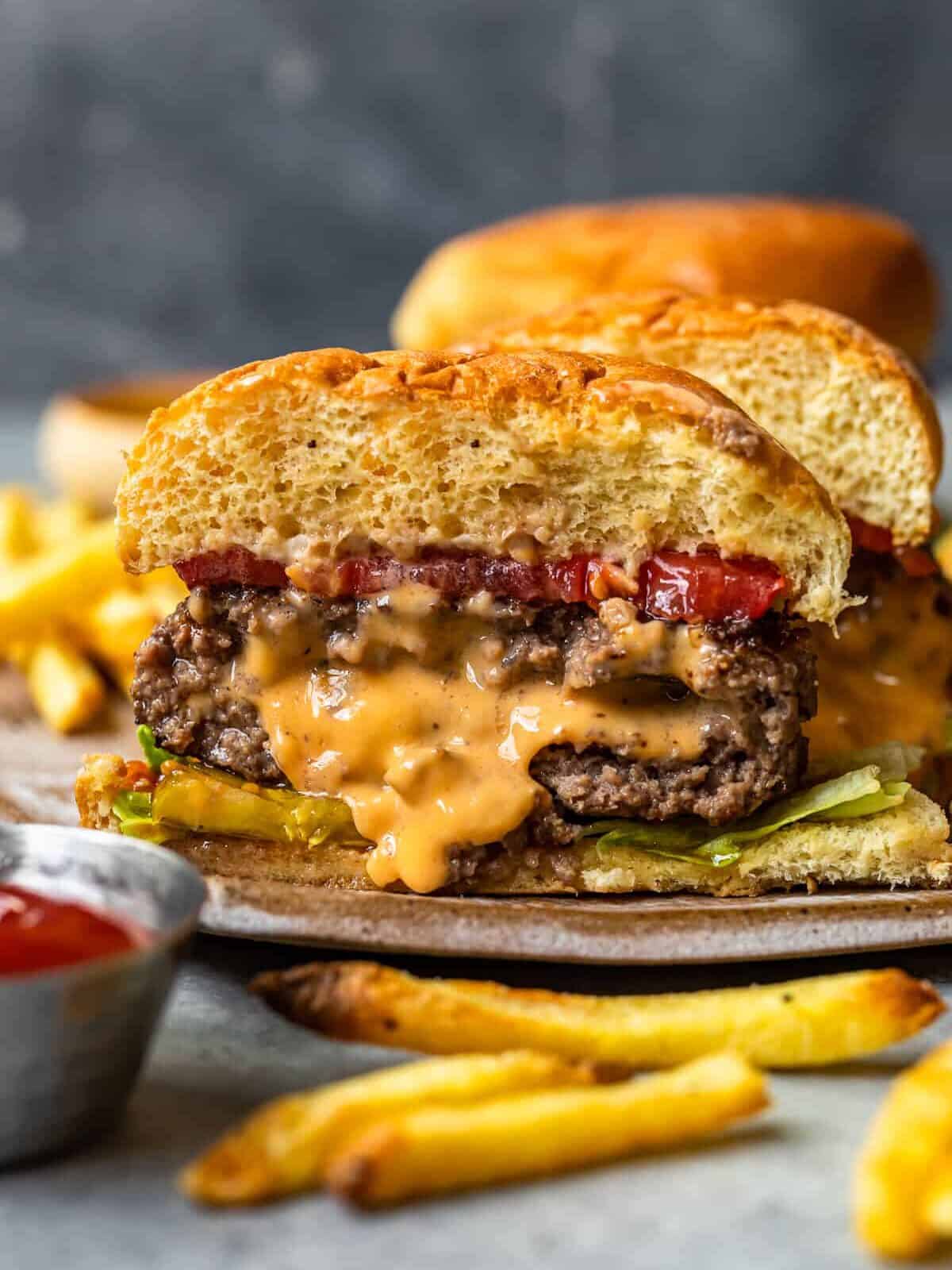 cheese stuffed burger cut in half showing the melted cheese filling