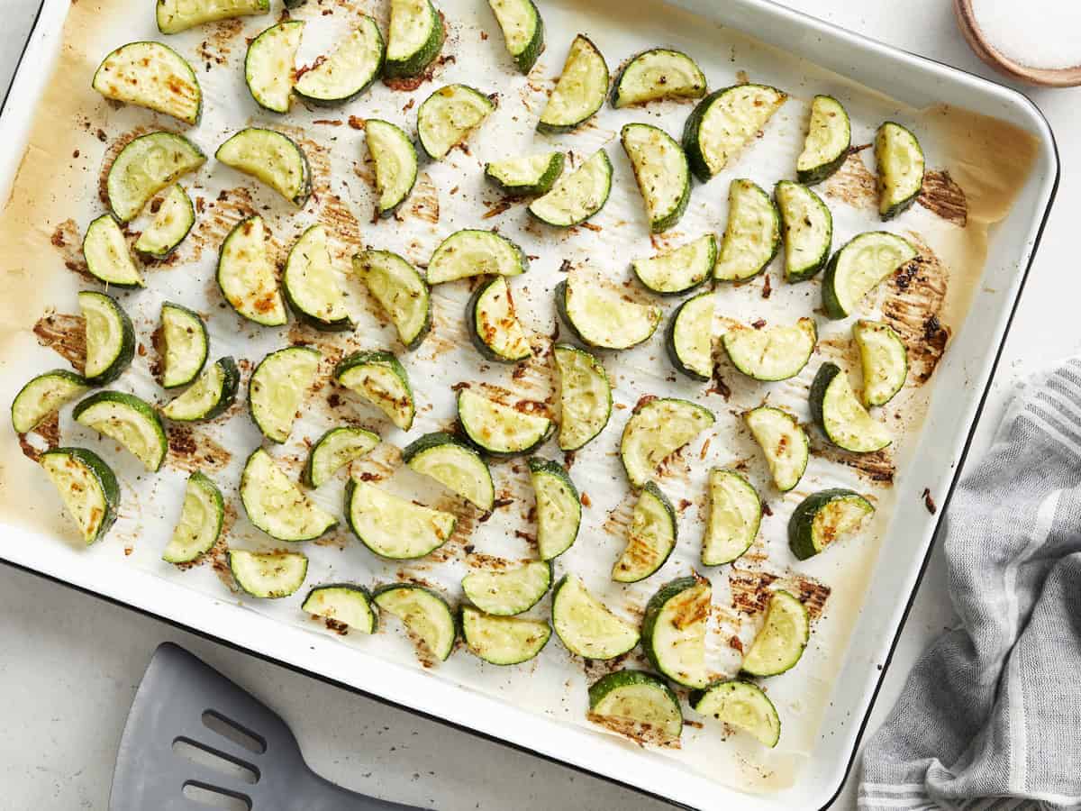 roasted zucchini on a baking sheet.