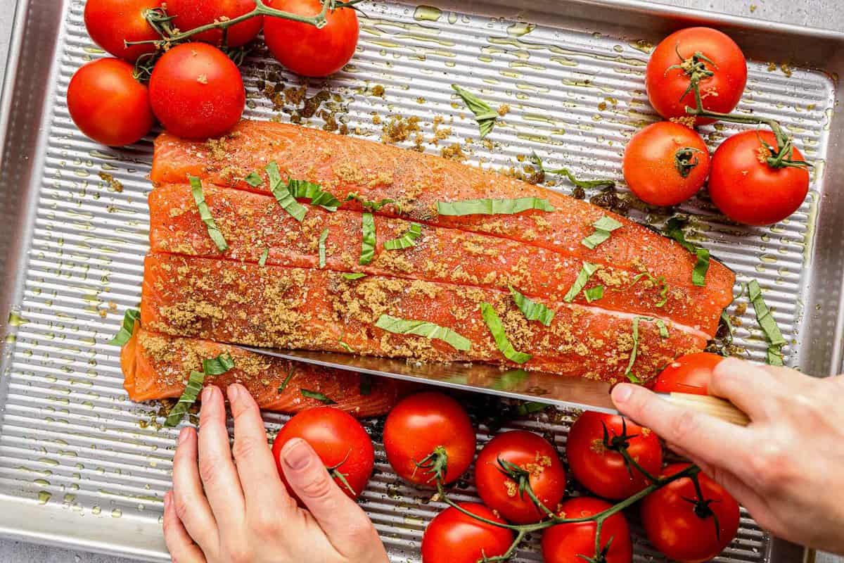 cutting slits into salmon to stuff.