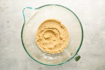 apple cider cookie dough in a glass stand mixer bowl.