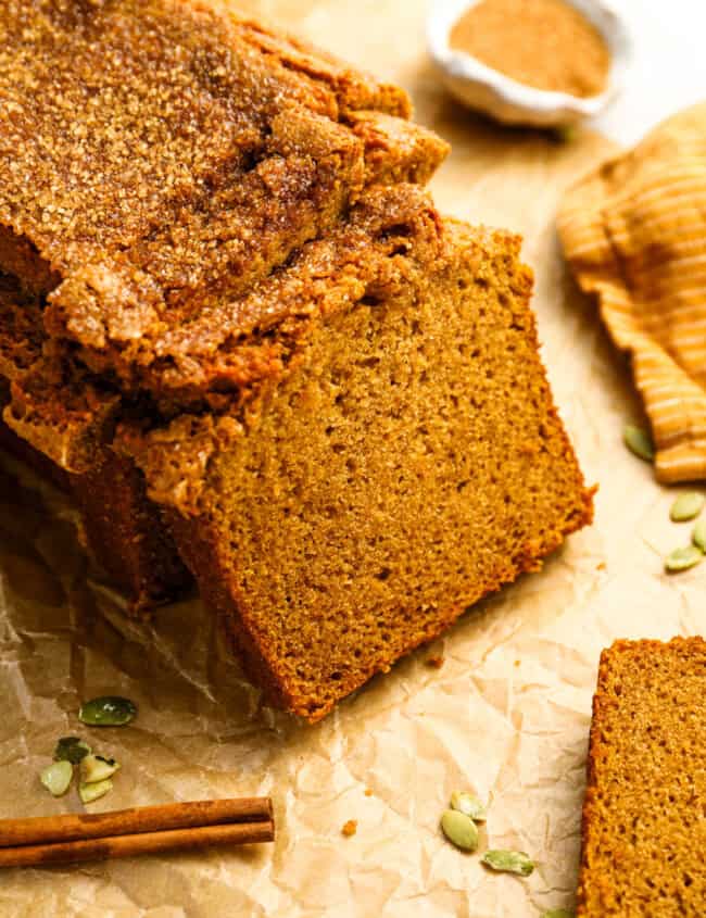 a partially sliced loaf of pumpkin bread.